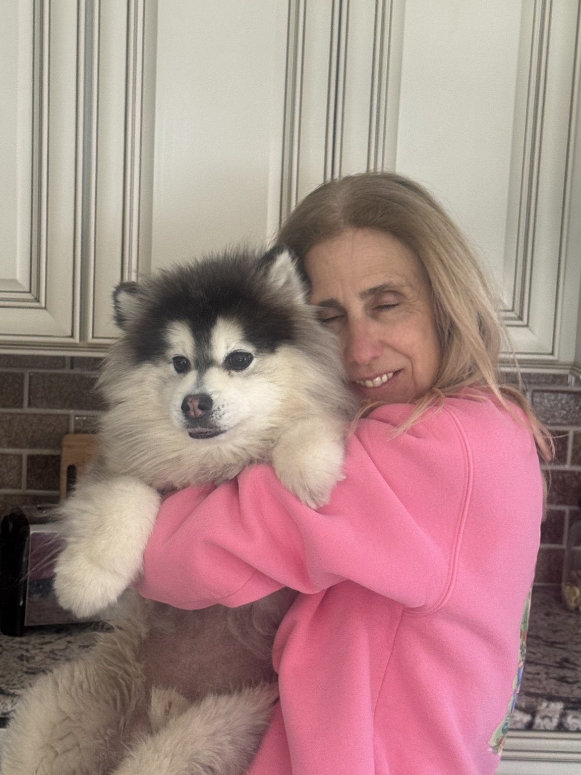 Annie holding a fluffy dog